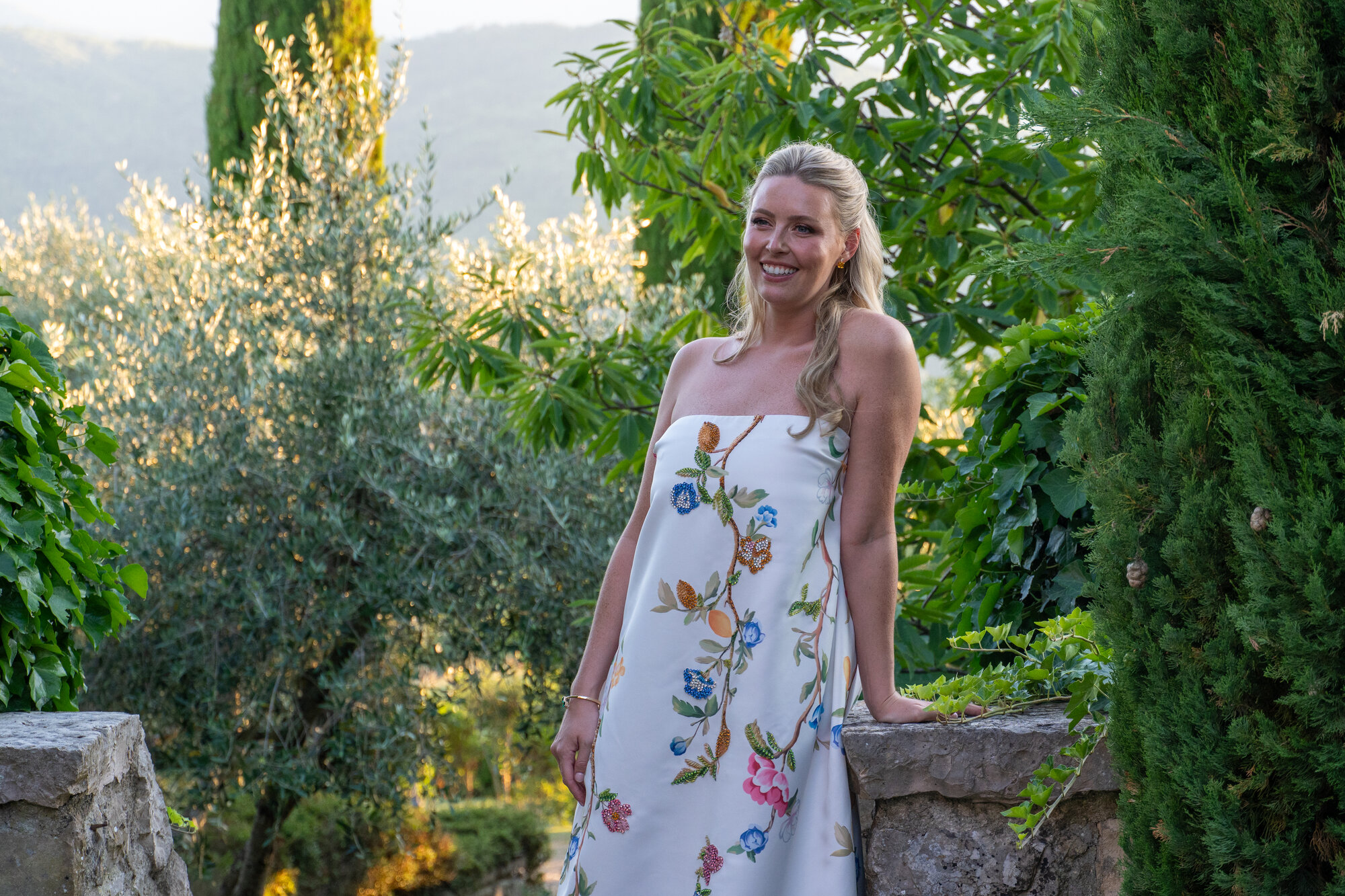 Couple embracing in a garden at golden hour
